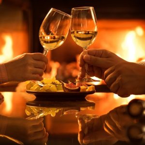 Young,Couple,Have,Romantic,Dinner,With,Wine,Over,Fireplace,Background.
